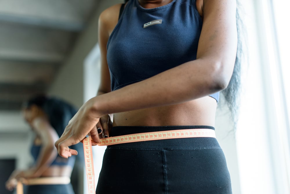 Woman measuring waist